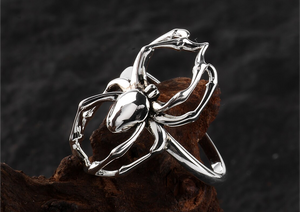 Gothic spider ring jewelry displayed on a dark and mysterious rock background, evoking an eerie and captivating ambiance